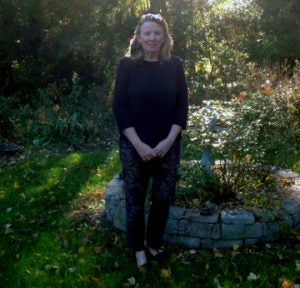 Barbara Dean, standing outside in a garden. 