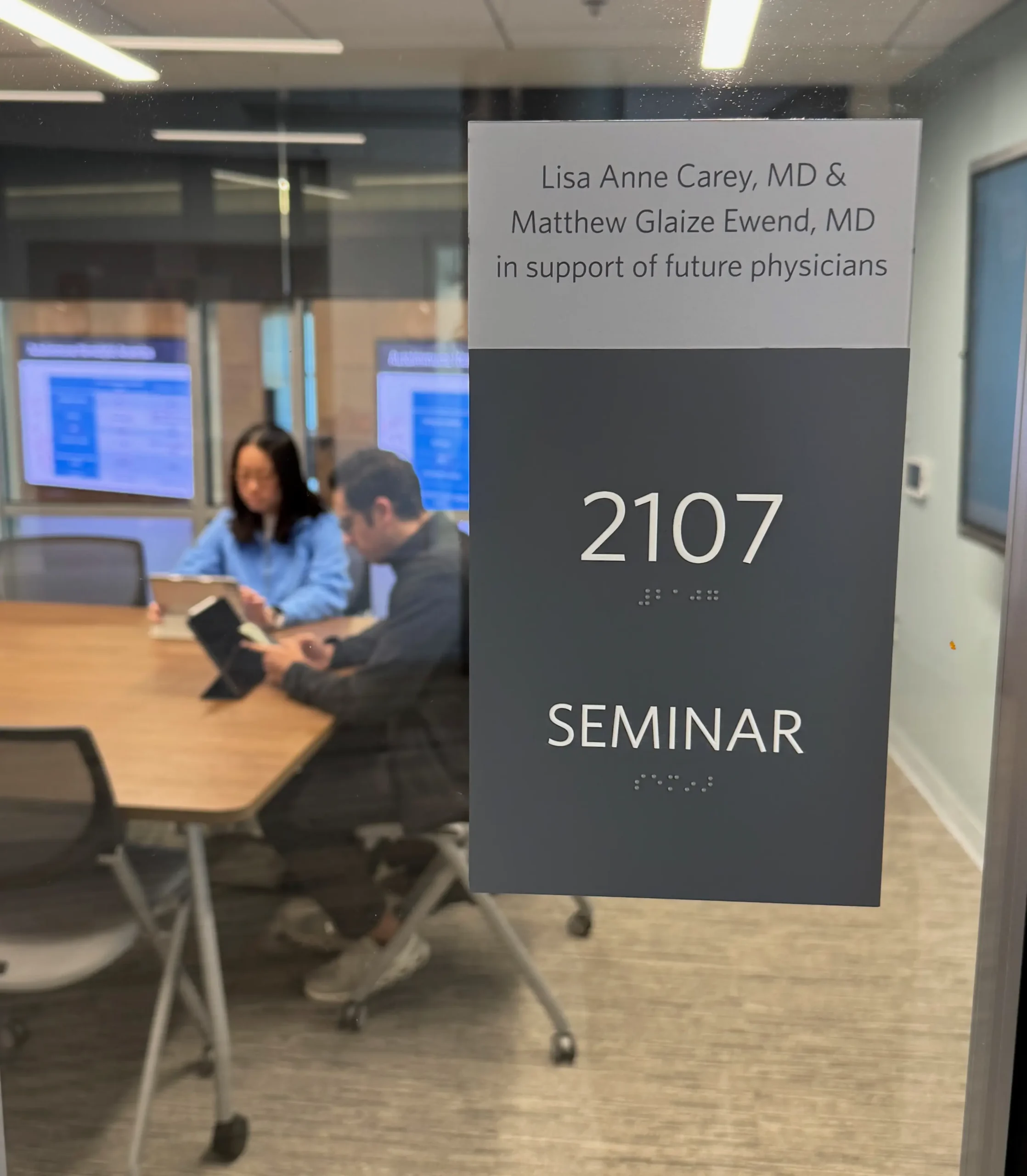 UNC School of Medicine students and foundation grant recipients study in a seminar room.