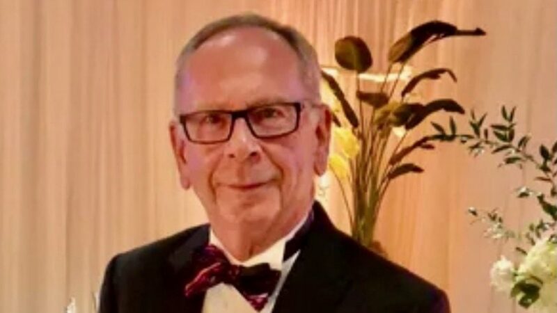 John Hammond, PhD, dressed in formal attire