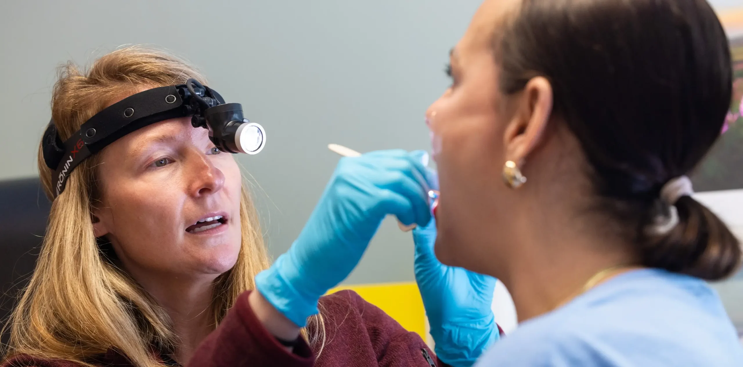 A UNC Health clinician performs a head and neck cancer screening at a community clinic established through foundation funding.