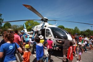 Children and families explore a UNC Health helicopter at a recent Touch a Truck event