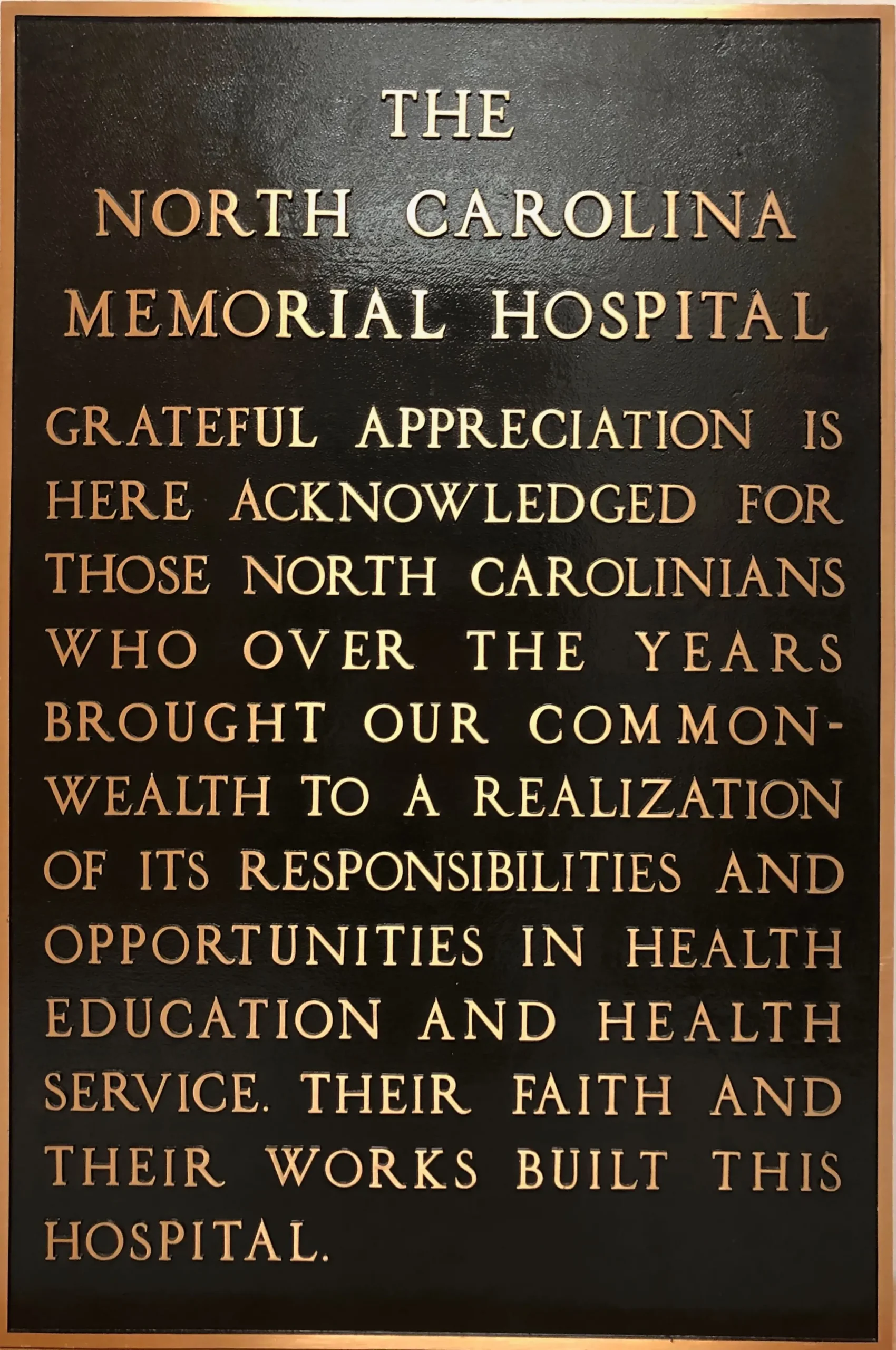 Commemorative bronze plaque honoring the founding of North Carolina Memorial Hospital and recognizing the people of North Carolina for supporting healthcare, education, and public service.
