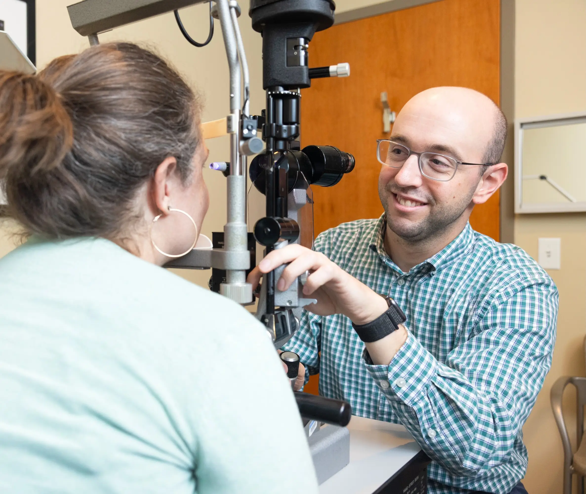 Ophthalmologist examines a patient who was able to access specialized clinical care through UNC Health Foundation