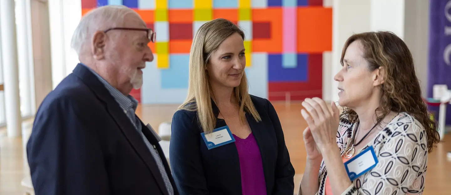 Blog featuring healthcare professionals and community members talking together at a healthcare research fundraising event