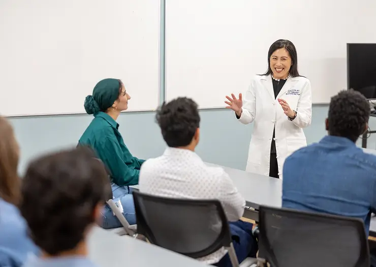 Physician shares new UNC research with a group of medical students in a classroom setting.