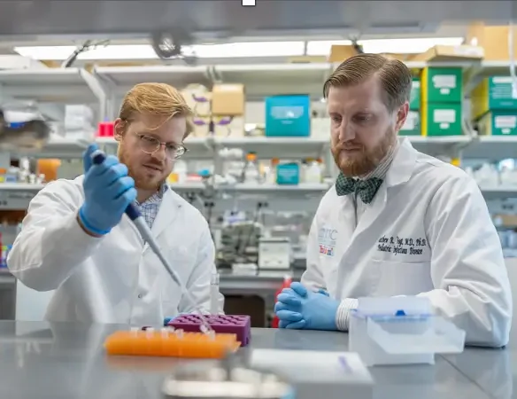 Two medical researchers use foundation funds for healthcare innovations in a laboratory