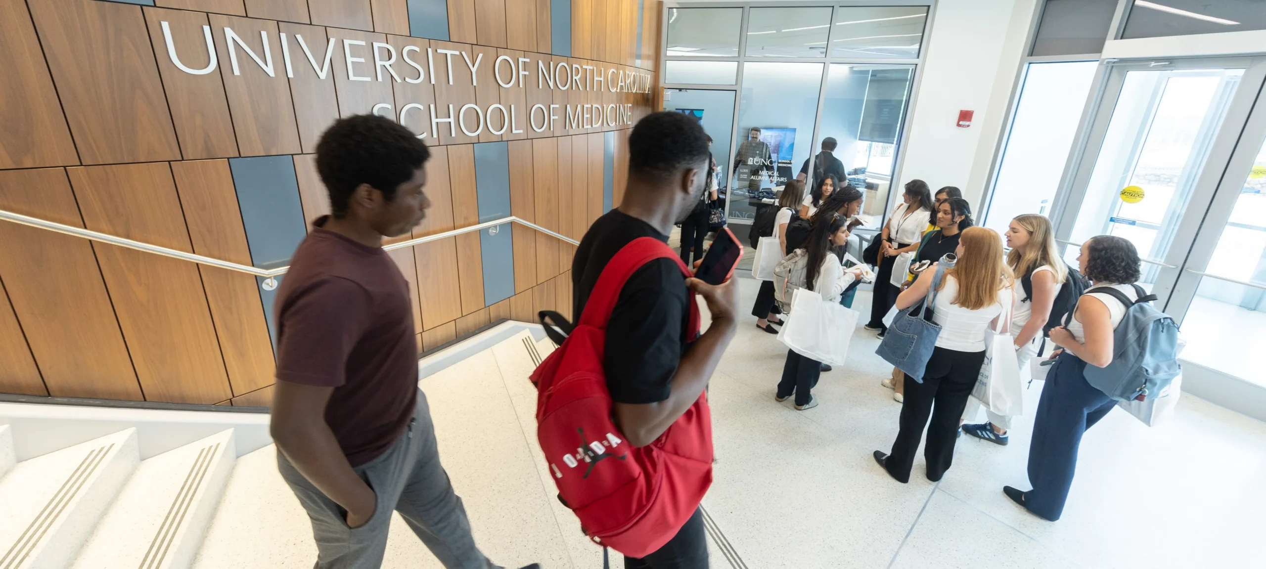 Medical students gather in the University of North Carolina School of Medicine lobby during an orientation, some on scholarship grants through foundation funding.