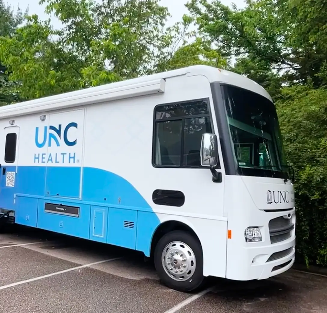 Mobile healthcare clinic vehicle parked outdoors, providing accessible medical services and preventive care to communities through convenient on-site healthcare.