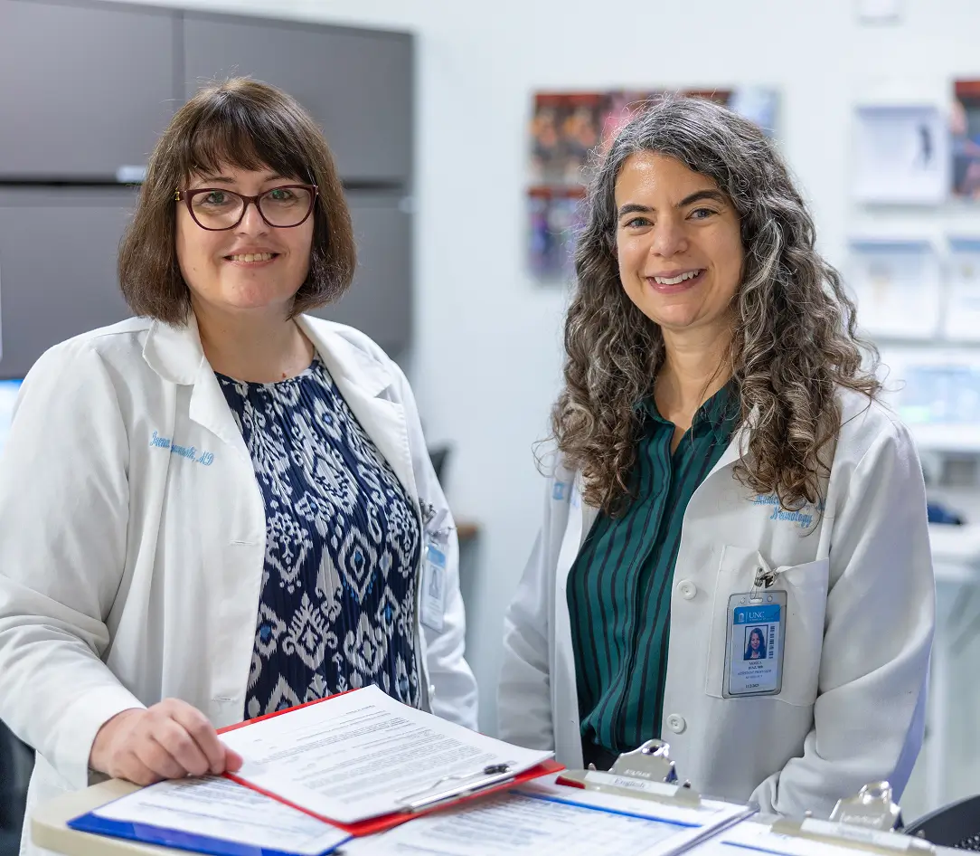 Two cancer research clinicians reviewing clinical documents together, highlighting collaboration in patient care and medical research made possible through corporate philanthropy and individual gifts