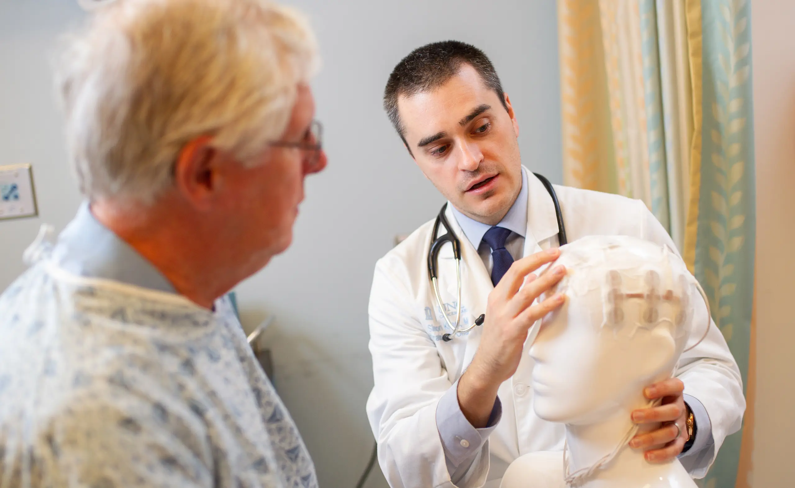 Provider with patient explaining a clinical neuro concept.