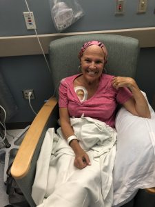 Patti Brenton smiling while receiving an infusion.