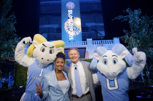 Janora McDuffie ’99, Master of Ceremonies, and Chancellor Kevin M. Guskiewicz celebrate the historic Campaign for Carolina with Rameses and RJ.